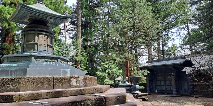 A stone structure with a pagoda in the middle of a forest